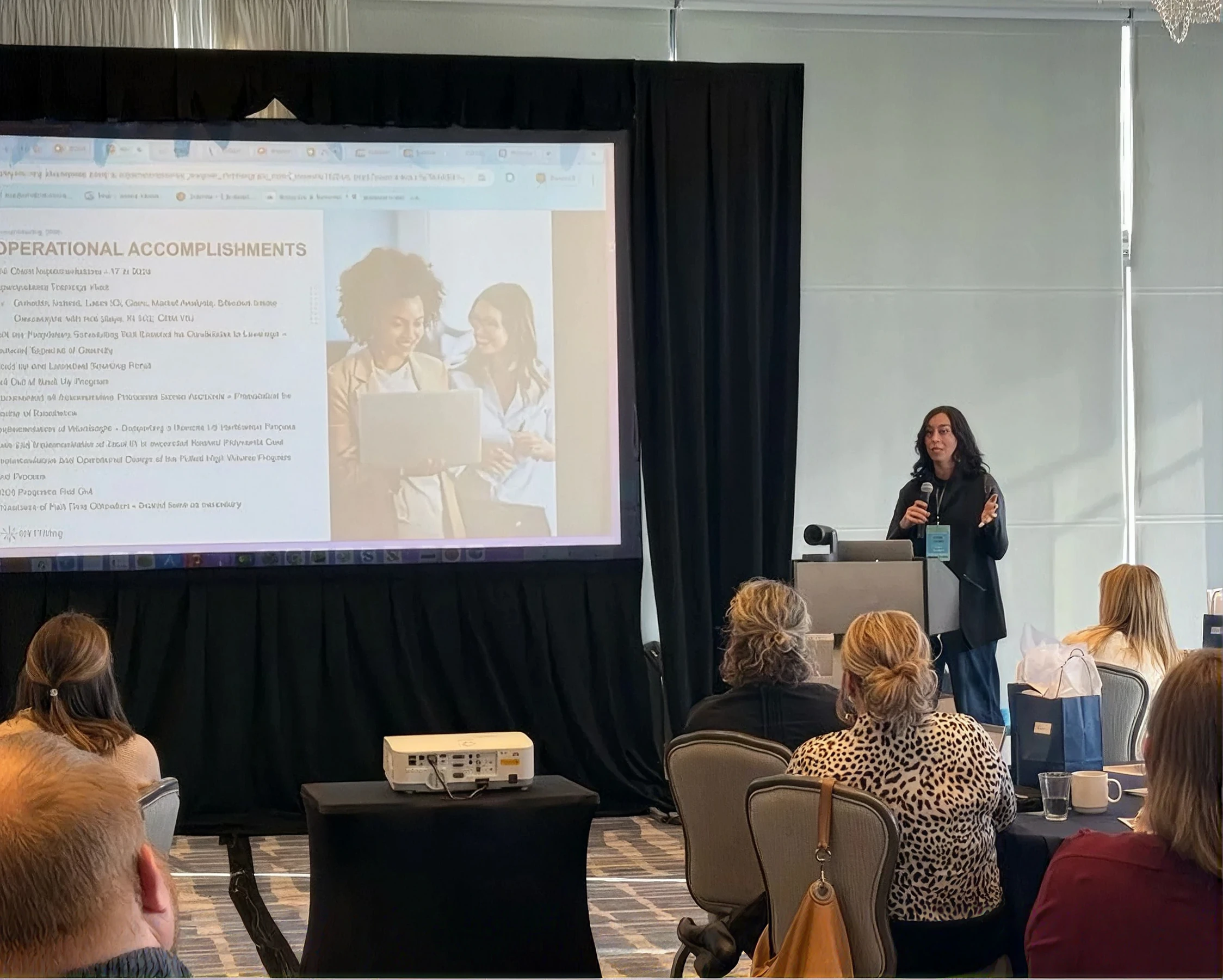 A speaker presenting NXTThing operational accomplishments to a conference audience